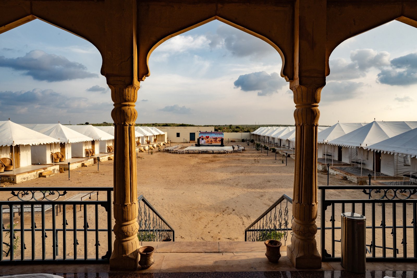 Desert camp courtyard framed by traditional arches